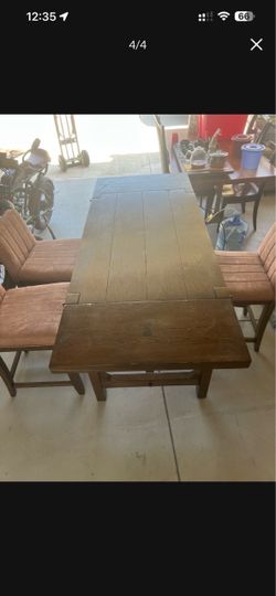 Solid wood dining table. Three solid wood and leather chairs