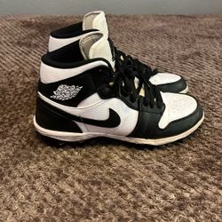 Jordan one has football cleats, black and white