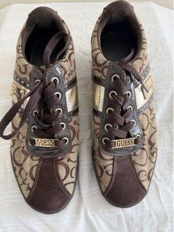older pair of GUESS women’s logo canvas sneakers.