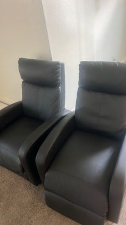 Twin black leather declining chairs