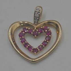 10KT YELLOW GOLD 2 GRAMS  HEART SHAPED PENDANT  W DIAMONDS AND RUBIES GOOD CONDITION. 