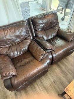 Two Leather Reclining Rocking Chairs