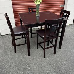 Dark red square wooden high table and four chairs