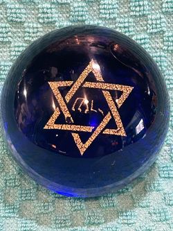 Vintage cobalt blue art glass paperweight featuring a gold-gilded Star of David