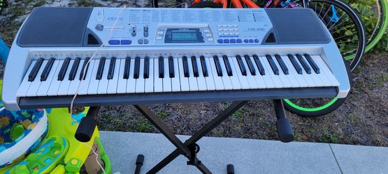 Keyboard With Stand And Power Cord.