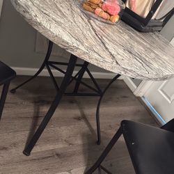 A Table With Three Chairs