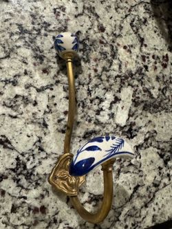 brass double wall hook featuring blue and white hand-painted porcelain finials