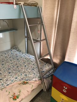 Wood bunk bed with mattresses and ladder