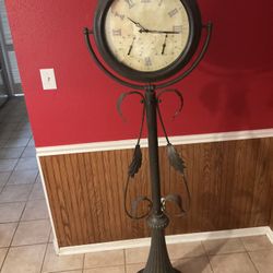 Crestview Collection 63" Metal Floor Clock with a Curled Iron Stand.