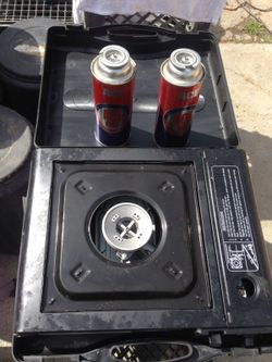 Portable gas range and two cartridges.