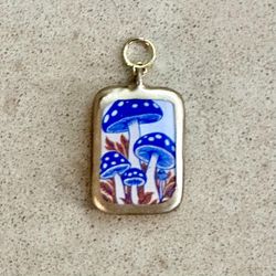 🍄 Darling blue mushrooms on white rectangle with gold border charm pendant
