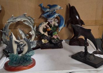 Beautiful collection of 5 decorative dolphin sculptures featuring a variety of designs, sizes, and finishes.