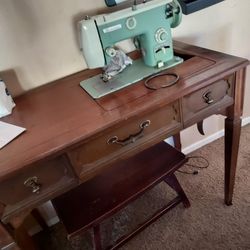 Sit Down To Sew At A Working  Taple With A Knee Pedal