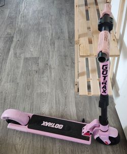 Electric Gotrax scooter with pink grips.