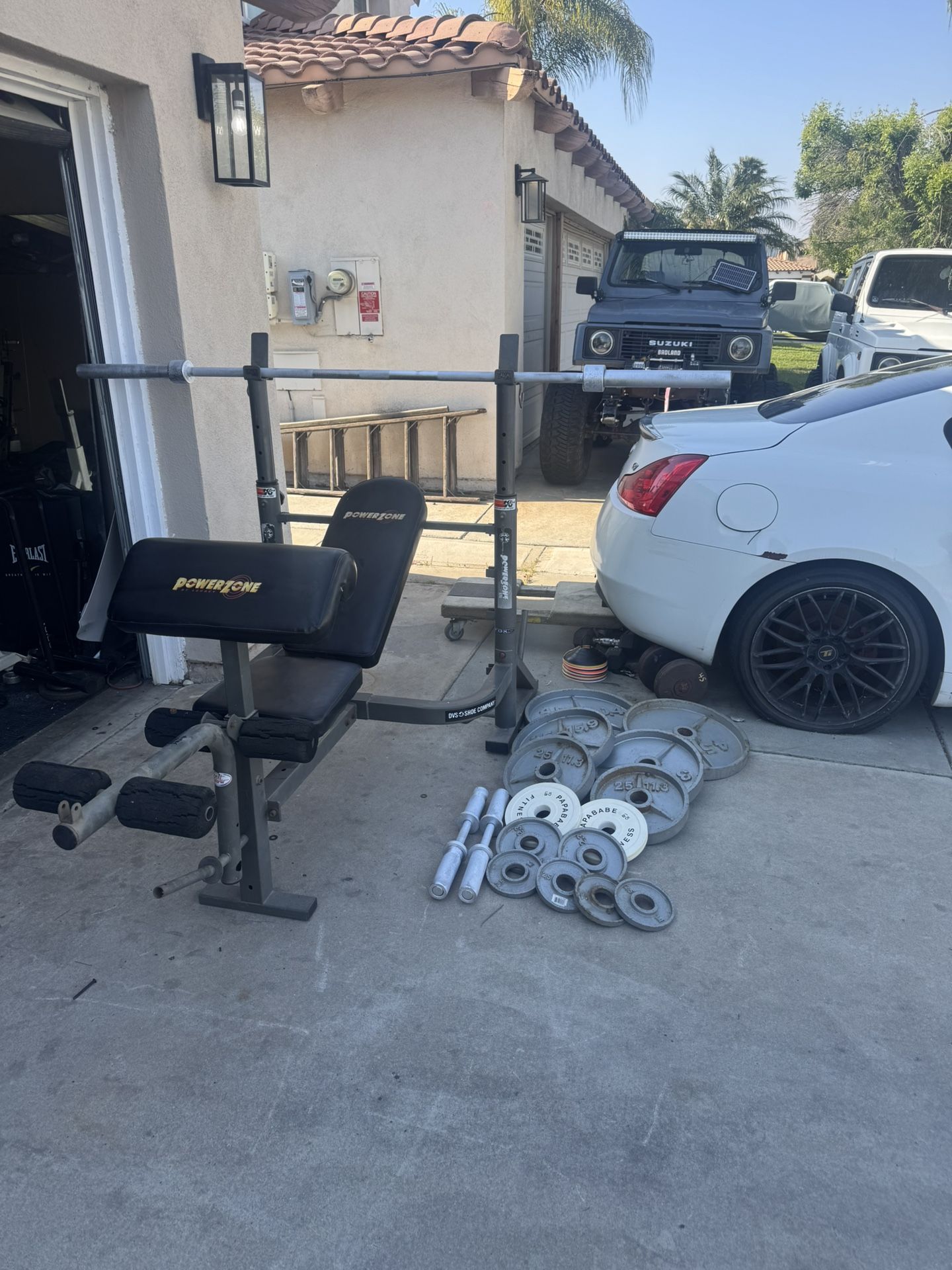 Bench press with 7ft 45lbs bar and 250lbs of Olympic weights and Olympic dumbbells handles