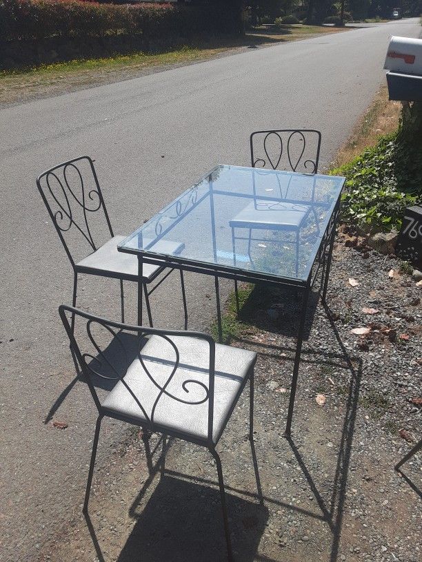 Wrought Iron Table. 3 Chairs.