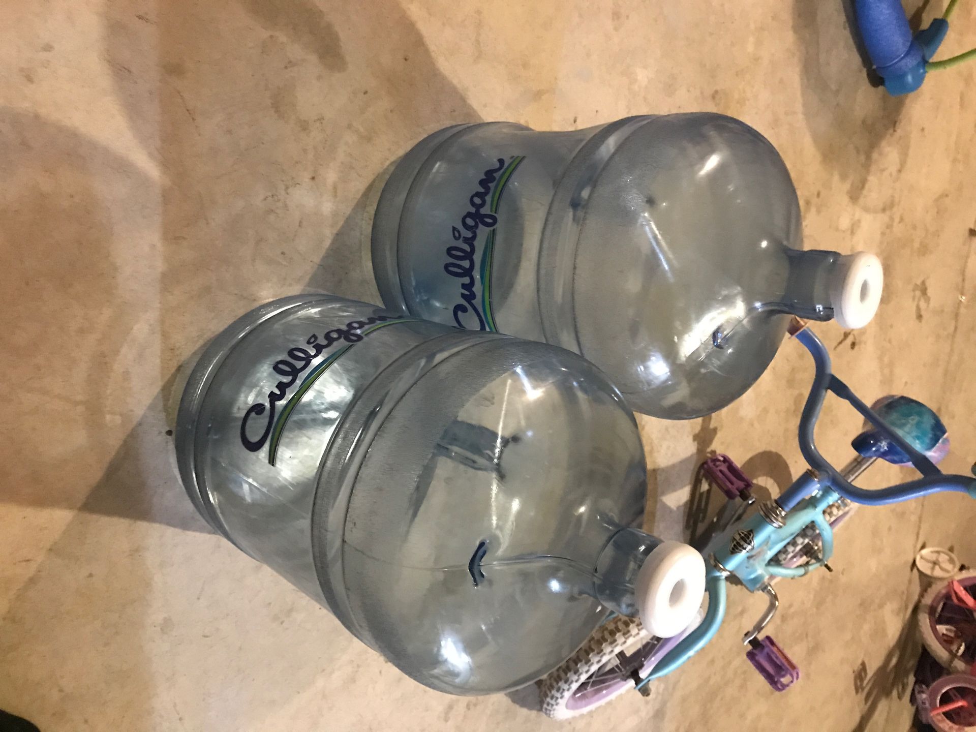 Two 5 gallon Culligan water jugs