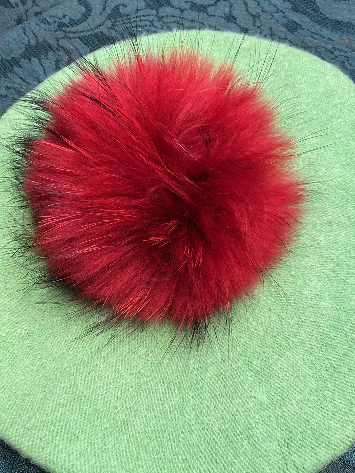 Green with red pompom beret