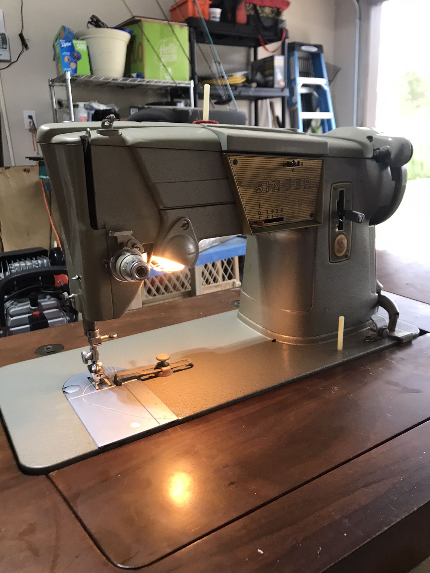 Vintage model singer 328 sewing machine in its on table
