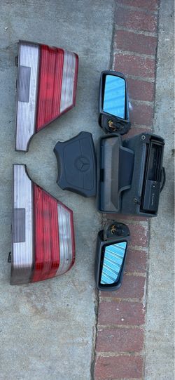 Genuine Mercedes-Benz automotive parts including  $80 pair of red and clear tail light    $ $50 two side-view mirrors with blue-tinted glass,   $100 a