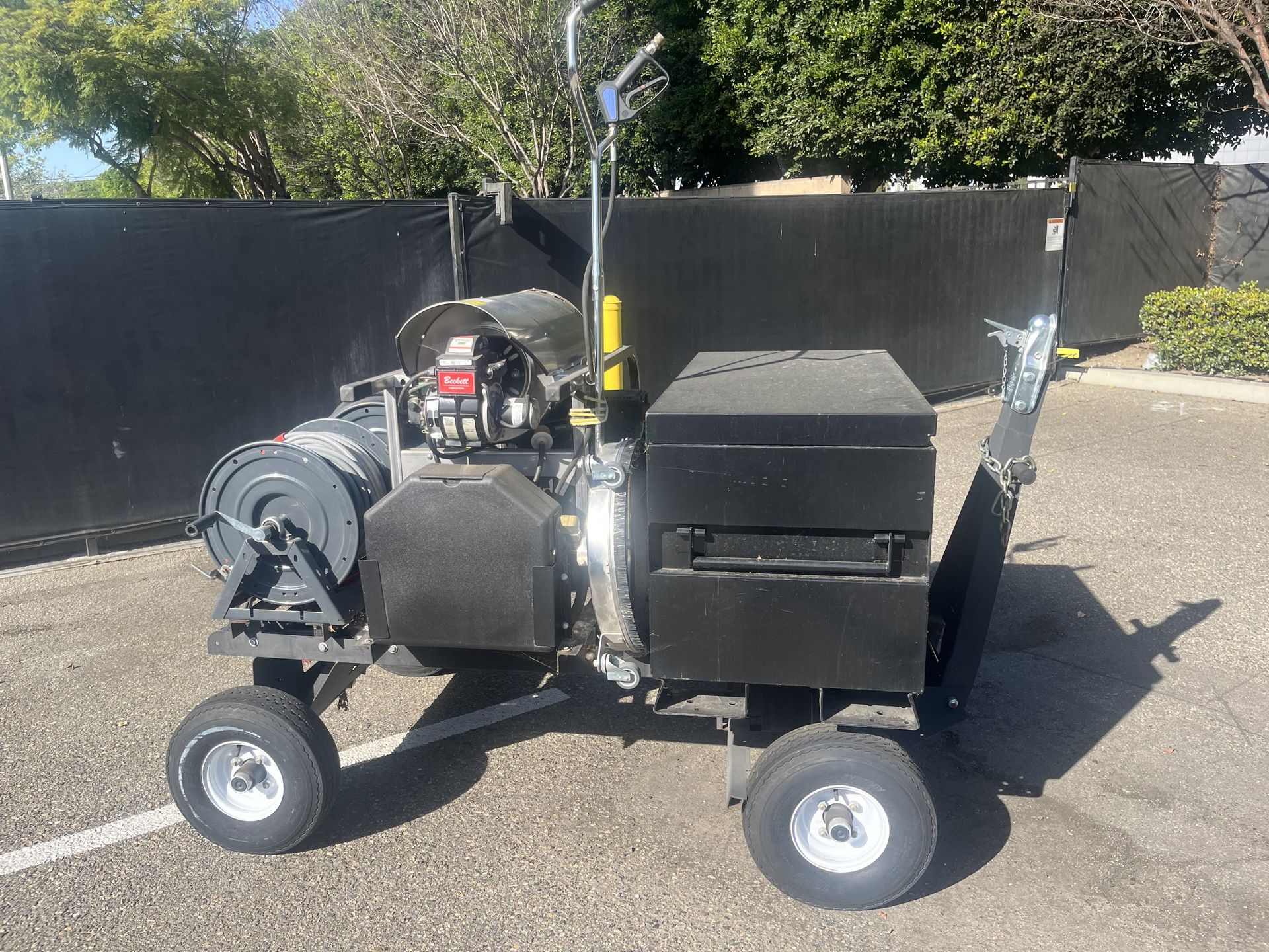 4000PSI pressure washer with steam cleaner. Mounted on easy tow push cart.