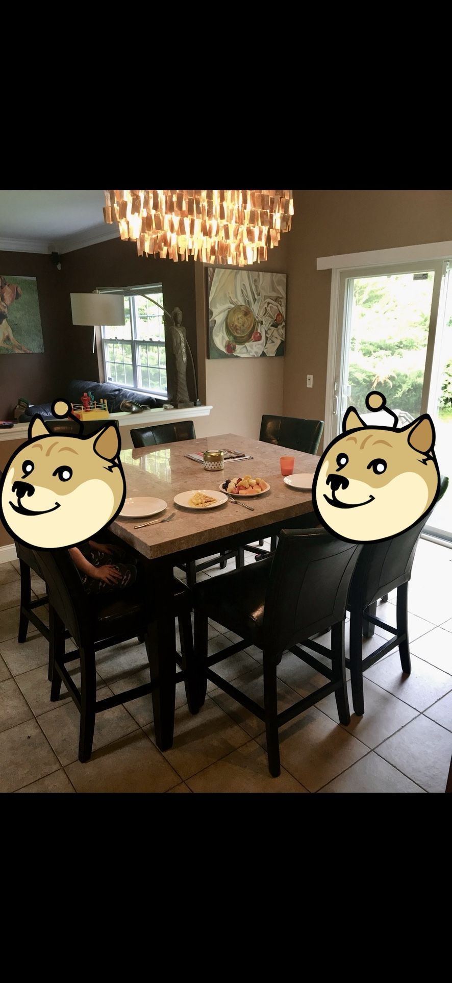 verview This is a dining room set featuring a rectangular faux marble top table and black upholstered chairs.