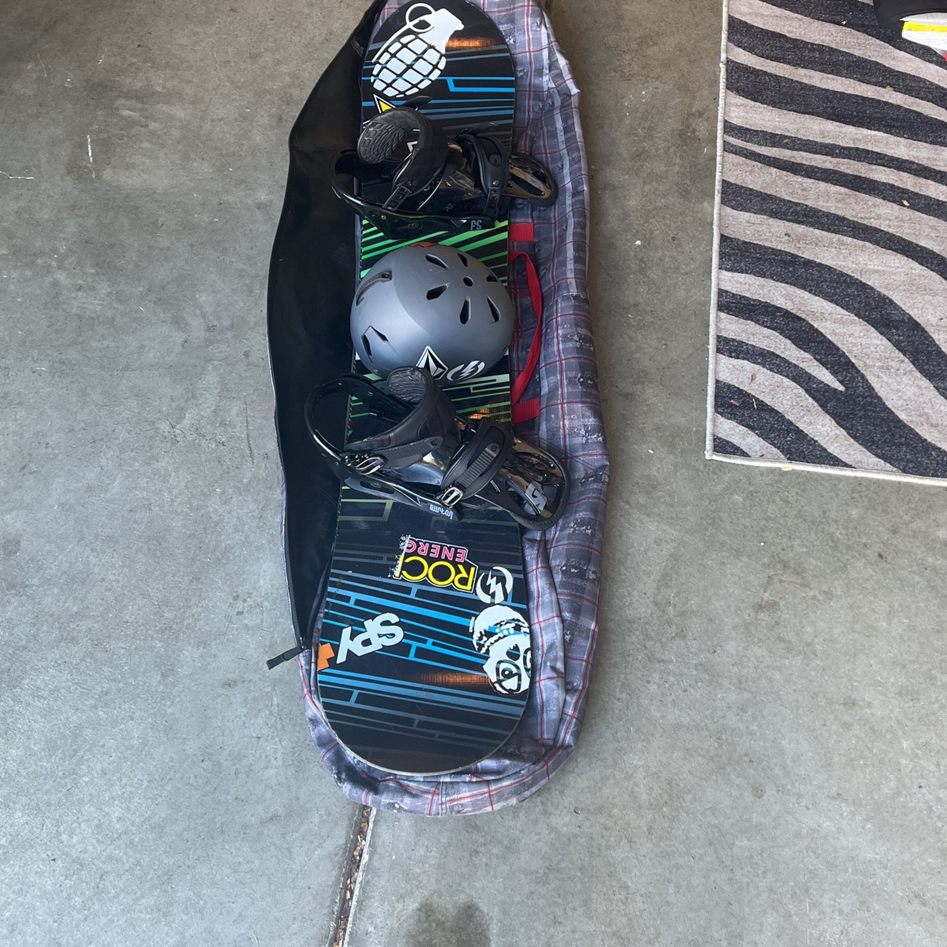 Snowboard with Bindings, Helmet, and Bag