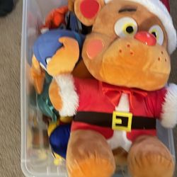 A box full of toys such as five night at Freddy’s and a Dog Man plush