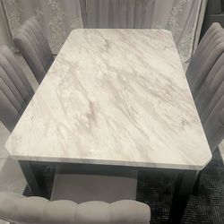 A luxurious dining table with chairs, in excellent condition—used for only one month—for $450. ( 77494)