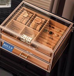 Amber/bronze glass jewelry box with gold metal trim and drawers.