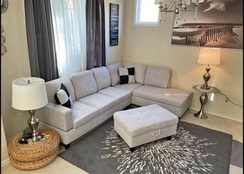 Gray linen sectional couch and ottoman