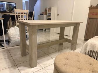 Light Oakwood trestle dining table 55” long  25 1/2 wide height 30 1/2