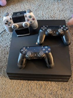PlayStation 4 with 3 wireless controllers and charging dock