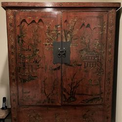 Ornately decorated large red antique Chinese cabinet