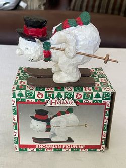 Vintage carved wooden skiing snowman holiday figurine.