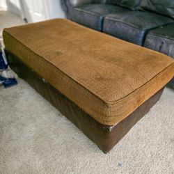 Brown Fabric Ottomon w/darker brown Leather base Xtra Long  Good Condition minor expected wear and tear