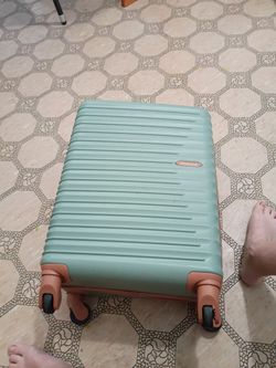 Green suitcase on wheels