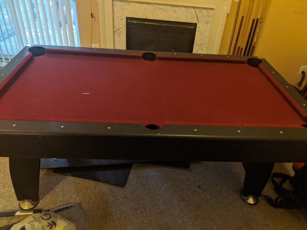 7 ft. Pool table with table tennis. Not sure of bran name.