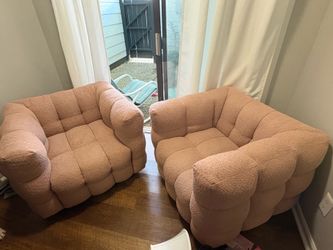 2 pink swivel chairs
