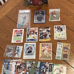 lot of NFL football  cards. Including rookie cards, an unopened football box, a Jalen Waddle PSA 10 clear vision rookie, Bijan rookie jersey card 