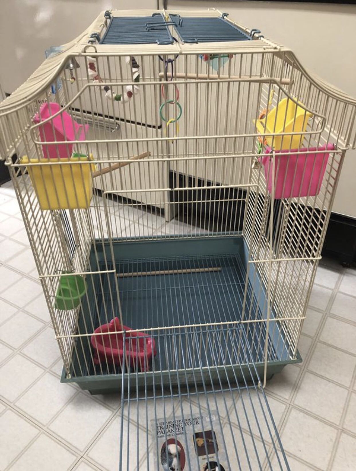 Large bird cage, plus small travel carrier, toys and feeding dishes and how-to book!