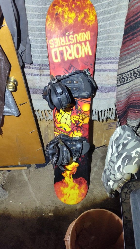 World Industries 141cm Snowboard With Bindings.