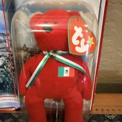 1. Ty Beanie Baby Osito the Bear from the International Bears II collection. The bear is red with a ribbon representing the Mexican flag