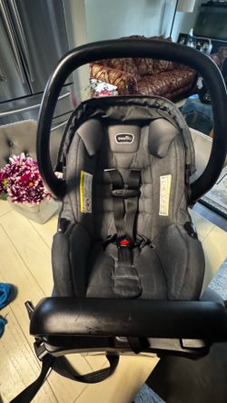Smoke free, pet free no accident Clean Evenflo infant car seat is charcoal gray and black. It has a matching base and a five-point harness system. The