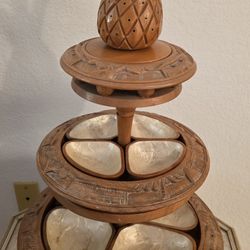 wood lazy susan, featuring a pineapple topper and shell-lined serving bowls