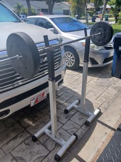 Squat uprights with 6 ft bar and two 25 lb plates