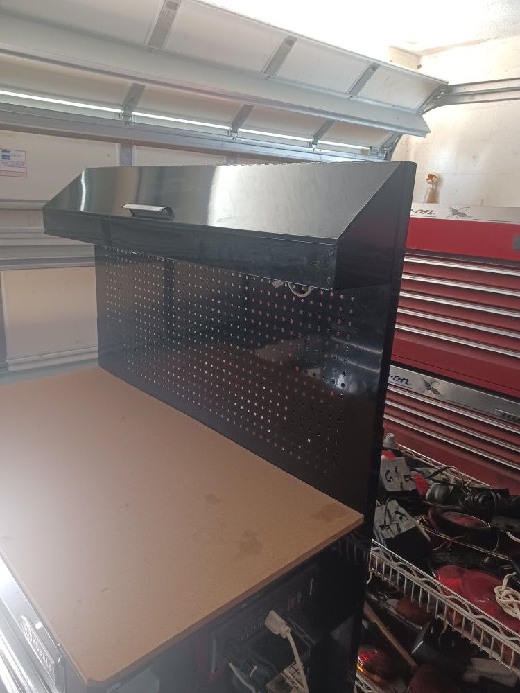 Kobalt Workbench. 3 Drawers . Compartment Above. Electric Outlets. Light Above. Steel Pegboard.