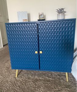 Blue Textured Cabinet With Gold Accents