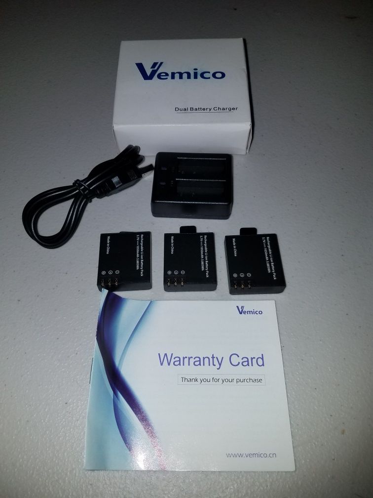 Action camera charger with batteries