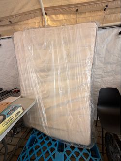 Full Size Mattress – Never Used, Stored in Plastic (Small Storage Mark on Cover)